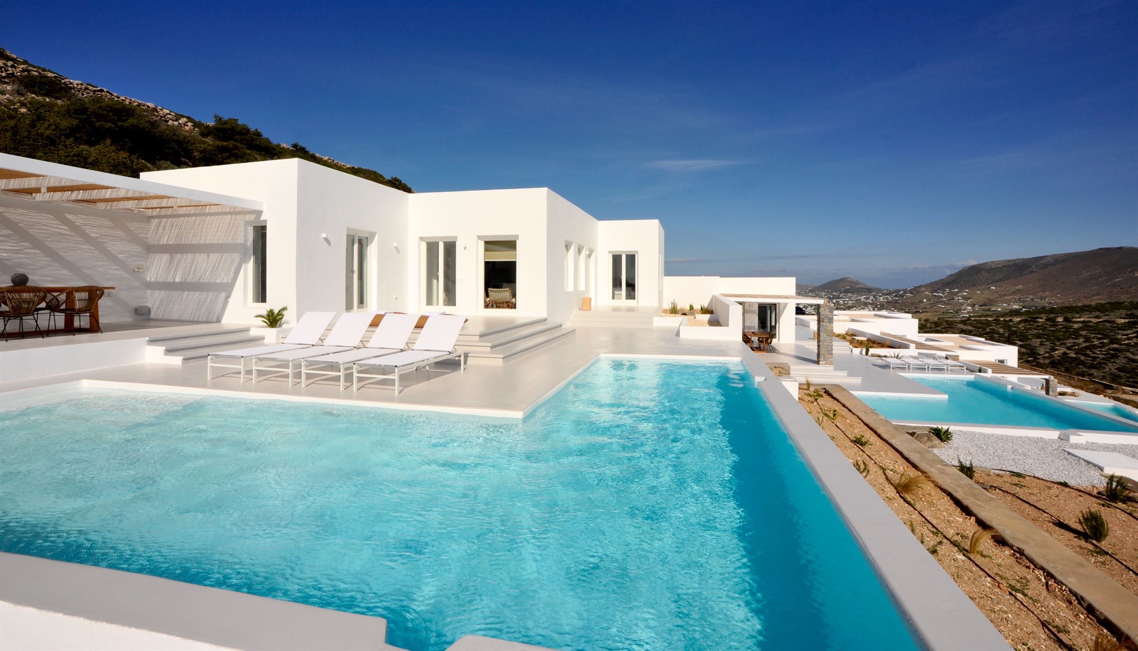 White Cycladic villa and turquoise private pool on the Paros hillside